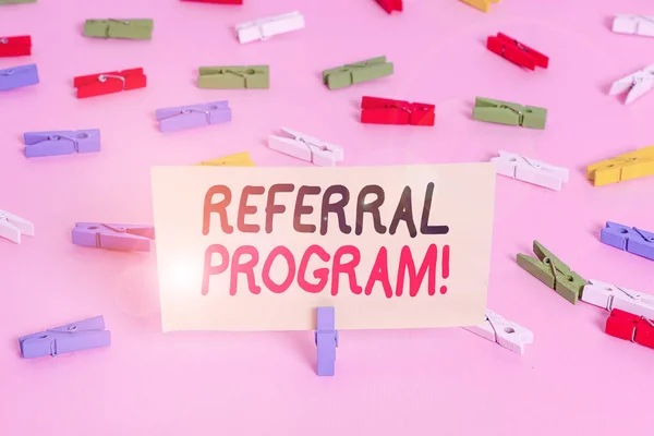 Conceptual hand writing showing Referral Program. Business photo showcasing internal recruitment method employed by organizations Colored clothespin papers empty reminder pink floor office.