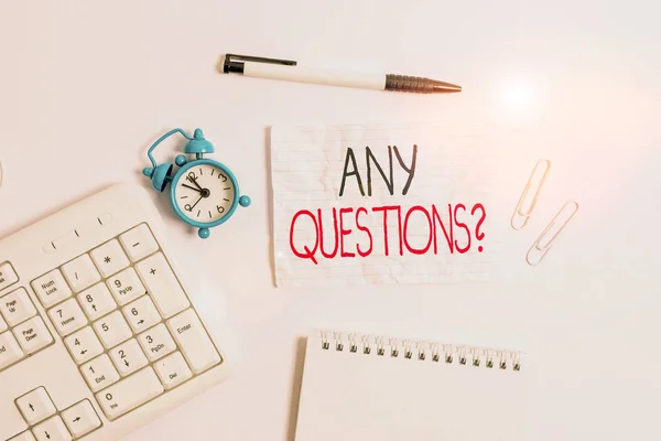 Conceptual hand writing showing Any Questions Question. Business photo showcasing you say write order to ask demonstrating about something Copy space on note paper with clock and pencil on the table.