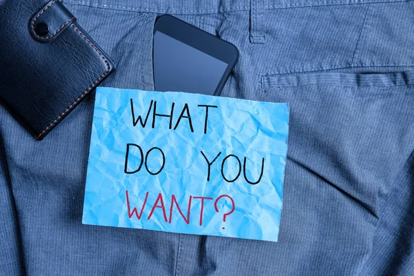 Text sign showing What Do You Want Question. Conceptual photo say or write in order to ask demonstrating about something Smartphone device inside trousers front pocket with wallet and note paper.