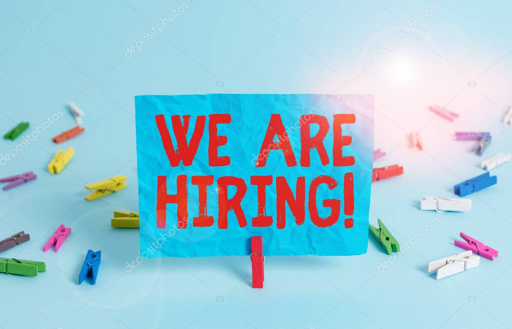 Writing note showing We Are Hiring. Business photo showcasing recently you employ someone or pay someone to do particular job Colored clothespin rectangle square shaped paper light blue background.
