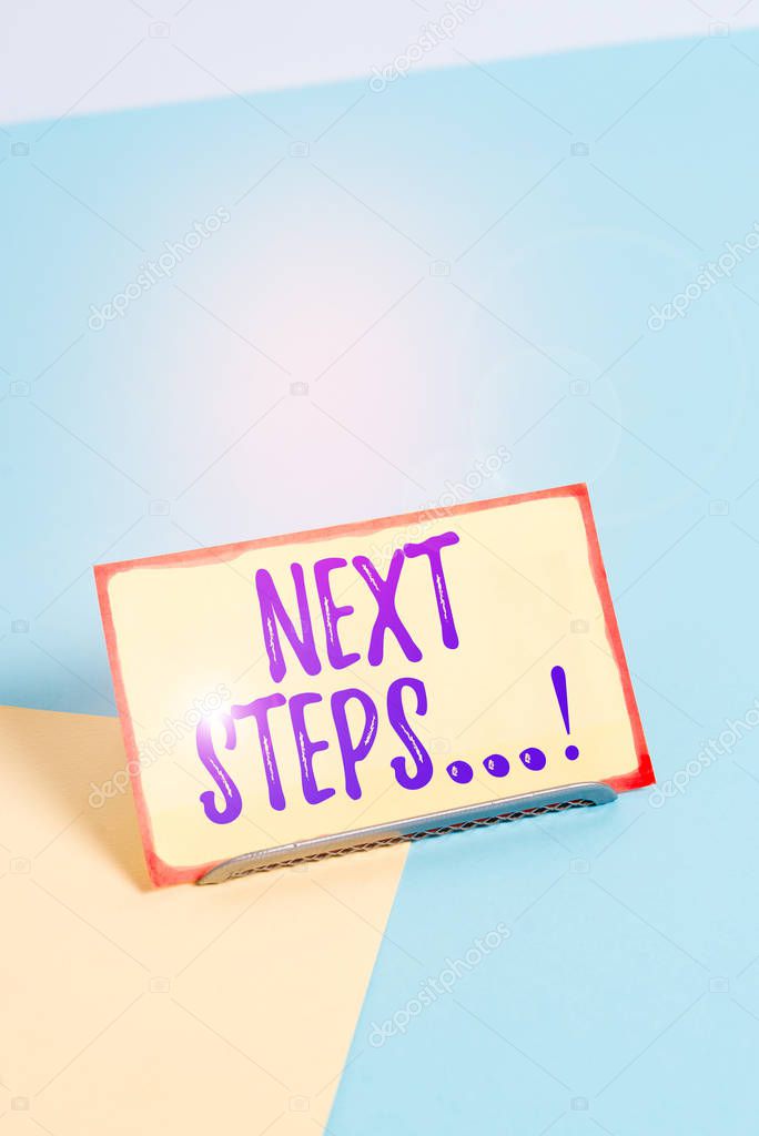 Text sign showing Next Steps. Conceptual photo something you do after you have finished doing first one Paper placed tilted above buffer wire on soft pastel multi colours backdrop.
