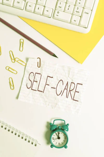 Handwriting text writing Self Care. Concept meaning practice of taking action to preserve or improve ones own health Flat lay above white blank paper with copy space for text messages. — Stock Photo, Image