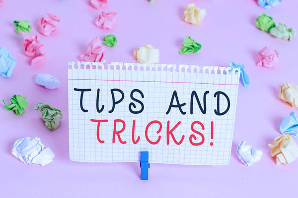 Writing note showing Tips And Tricks. Business photo showcasing means piece advice maybe suggestion how improve Colored crumpled papers empty reminder pink floor background clothespin.