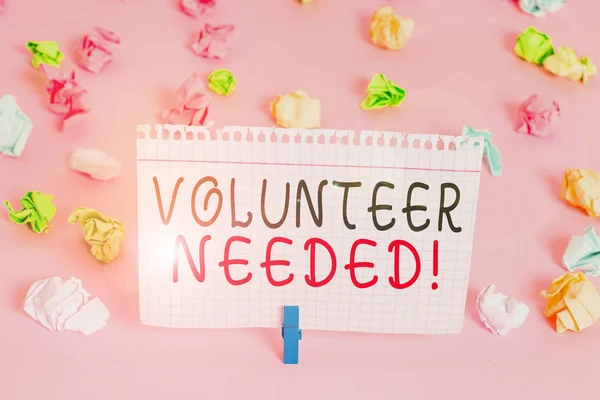 Writing note showing Volunteer Needed. Business photo showcasing asking demonstrating to work for organization without being paid Colored crumpled papers empty reminder pink floor background clothespi