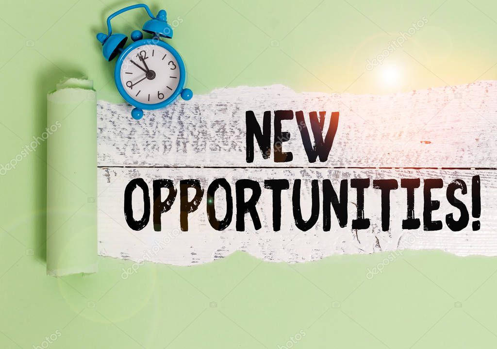 Writing note showing New Opportunities. Business photo showcasing exchange views condition favorable for attainment goal Alarm clock and torn cardboard on a wooden classic table backdrop.