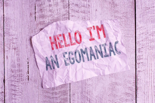 Text sign showing Hello I am An Egoanalysisiac. Conceptual photo Selfish Egocentric Narcissist Selfcentered Ego Crumpled torn paper half broken placed above classic wooden background.