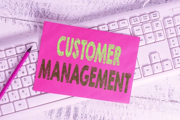 Handwriting text writing Customer Management. Concept meaning customer retention and ultimately driving sales growth White keyboard office supplies empty rectangle shaped paper reminder wood.