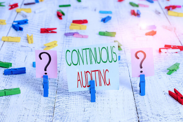 Text sign showing Continuous Auditing. Conceptual photo Internal process that examines accounting practices Scribbled and crumbling sheet with paper clips placed on the wooden table.