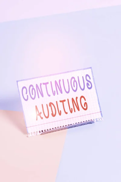 Text sign showing Continuous Auditing. Conceptual photo Internal process that examines accounting practices Paper placed tilted above buffer wire on soft pastel multi colours backdrop. — Stock Photo, Image