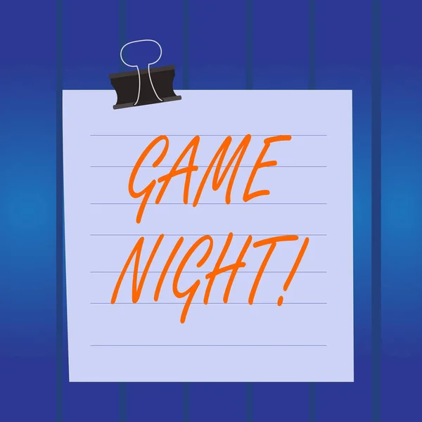 Writing note showing Game Night. Business photo showcasing usually its called on adult play dates like poker with friends Paper lines binder clip suare notebook color background. — Stock Photo, Image