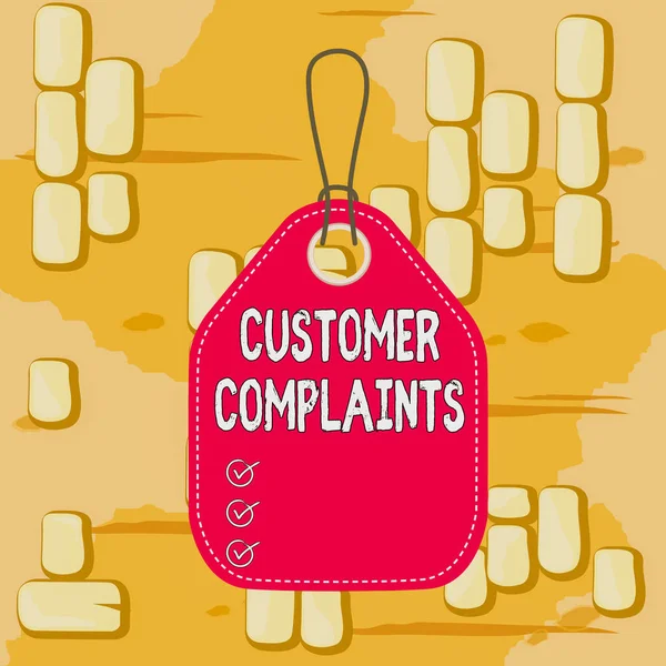 Word writing text Customer Complaints. Business concept for expression of dissatisfaction on a consumer s is behalf Empty tag blank space colorful background label rectangle attached string.