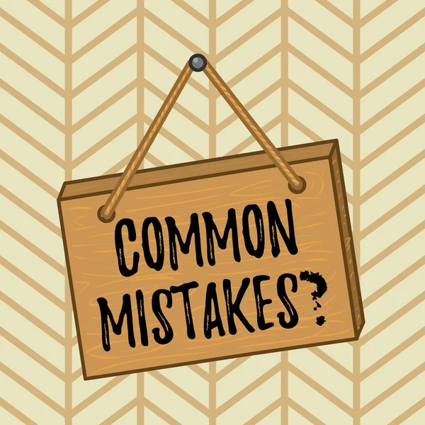 Word writing text Common Mistakes question. Business concept for repeat act or judgement misguided or wrong Square rectangle unreal cartoon wood wooden hang down on the coloured wall. — Stock Photo, Image