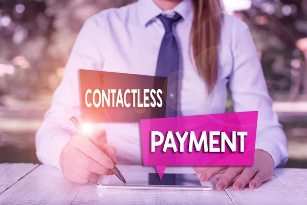 Handwriting text Contactless Payment. Concept meaning use near field communication for making secure payments Female business person sitting by table and holding mobile phone.
