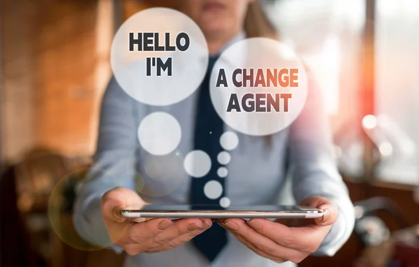 Conceptual hand writing showing Hello I am A Change Agent. Business photo text Promoting and enabling difference evolution new Woman in the background pointing with finger in empty space.