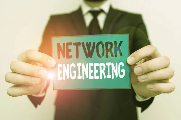 Writing note showing Network Engineering. Business photo showcasing field concerned with internetworking service requirement Male human wear formal work suit with office look hold book.