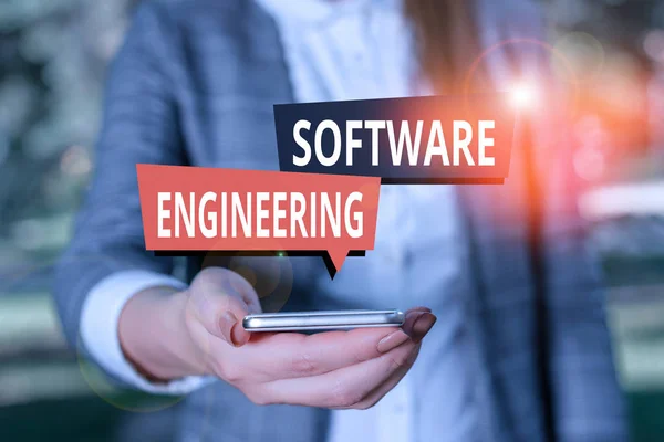 Text sign showing Software Engineering. Conceptual photo apply engineering to the development of software Woman in grey suites holds mobile phone. — Stockfoto