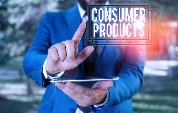 Text sign showing Consumer Products. Conceptual photo goods bought for consumption by the average consumer Businessman in blue suite with a tie holds lap top in hands.