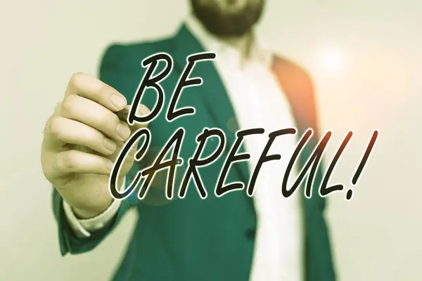 Word writing text Be Careful. Business concept for making sure of avoiding potential danger mishap or harm Businessman with pointing finger in front of him. — Stock Photo, Image