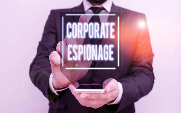 Conceptual hand writing showing Corporate Espionage. Business photo text form of espionage conducted for commercial purpose Male human wear formal work suit hold smartphone using hand.