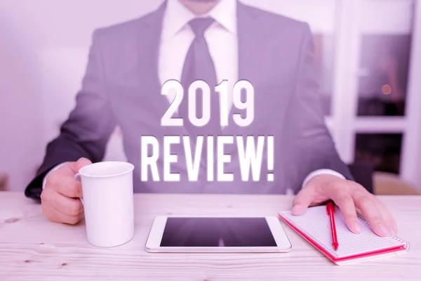 Conceptual hand writing showing 2019 Review. Business photo showcasing remembering past year events main actions or good shows Male human wear formal clothes present use hitech smartphone. — Stok fotoğraf