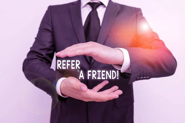 Handwriting text writing Refer A Friend. Concept meaning direct someone to another or send him something like gift Male human with beard wear formal working suit clothes raising one hand up. — Stock Photo, Image