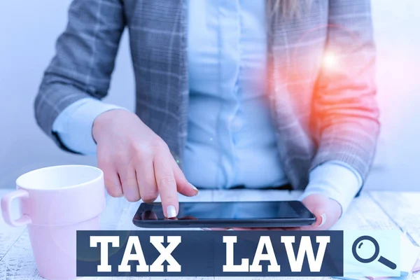 Word writing text Tax Law. Business concept for governmental assessment upon property value or transactions Business woman sitting with mobile phone and cup of coffee on the table. — ストック写真
