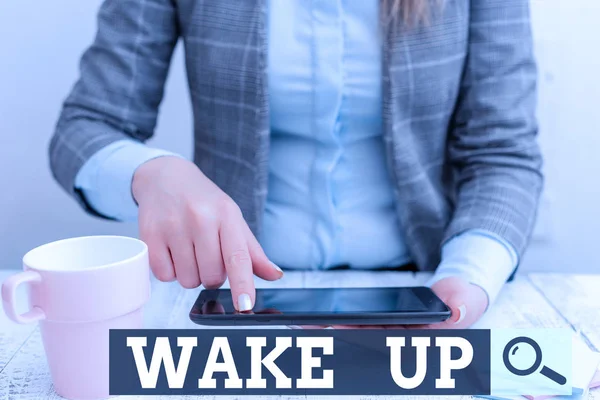 Word writing text Wake Up. Business concept for an instance of a demonstrating waking up or being woken up Rise up Business woman sitting with mobile phone and cup of coffee on the table.