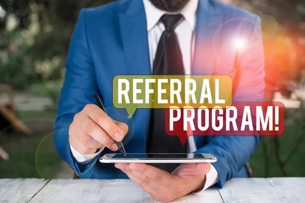 Text sign showing Referral Program. Conceptual photo internal recruitment method employed by organizations Businessman pointing with pen in empty copy space. — Stock Photo, Image