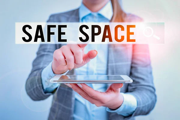 Word writing text Safe Space. Business concept for a place or room in which you are protected from harm or danger Business concept with mobile phone and business woman.