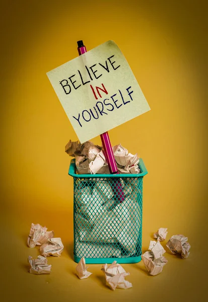 Writing note showing Believe In Yourself. Business photo showcasing common piece of advice that you can do everything crumpled paper and stationary with paper placed in the trash can. — Stock Photo, Image