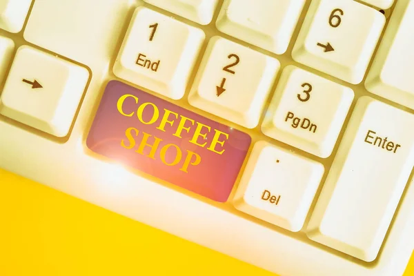 Conceptual hand writing showing Coffee Shop. Business photo showcasing small informal restaurant serving coffee and light refreshments White pc keyboard with note paper above the white background. — Stockfoto