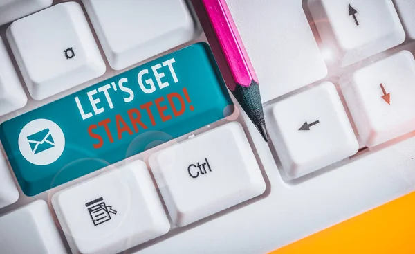 Writing note showing Let S Get Started. Business photo showcasing encouraging someone to begin doing something White pc keyboard with note paper above the white background.