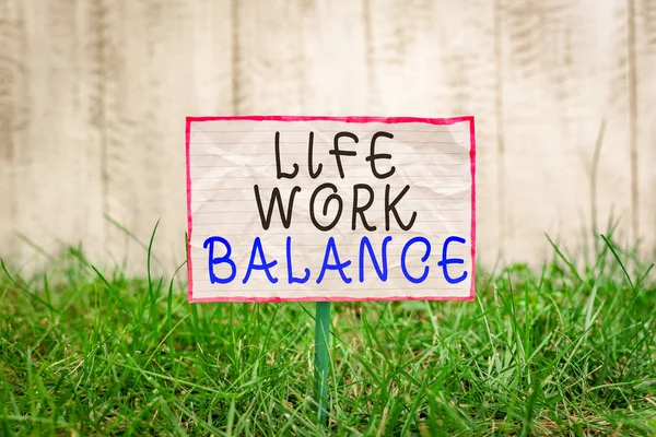 Text sign showing Life Work Balance. Conceptual photo stability demonstrating needs between his job and demonstratingal time Crumpled paper attached to a stick and placed in the green grassy land.