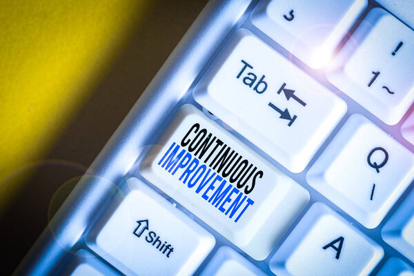Writing note showing Continuous Improvement. Business photo showcasing ongoing effort to improve products or processes White pc keyboard with note paper above the white background.