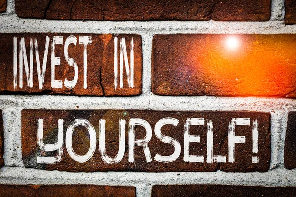 Writing note showing Invest In Yourself. Business photo showcasing nvesting in a coach or a training to learn new things Front view red brick wall facade background Old grunge scenery. — Stock Photo, Image