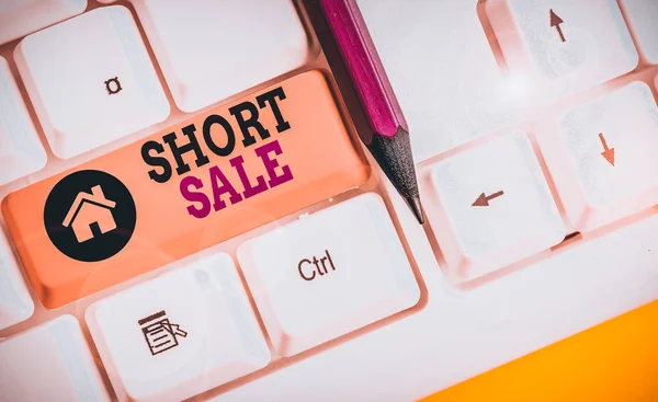 Escrita à mão escrita de texto Short Sale. Conceito significado Home que é oferecido a um preço que é menor do que a quantidade devida teclado pc branco com papel de nota vazio acima espaço de cópia de chave de fundo branco . — Fotografia de Stock