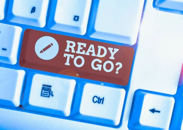 Text sign showing Ready To Go Question. Conceptual photo asking someone if he is prepared or packed his things White pc keyboard with empty note paper above white background key copy space.