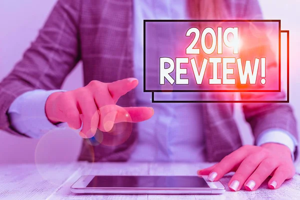 Writing note showing 2019 Review. Business photo showcasing remembering past year events main actions or good shows Business woman sitting with mobile phone on the table. — Stok fotoğraf