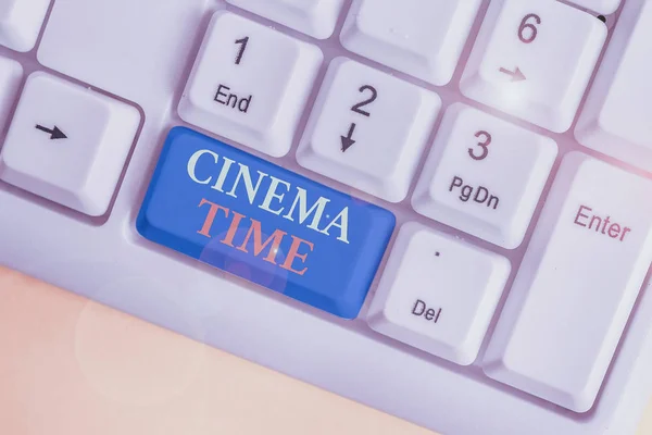 Conceptual hand writing showing Cinema Time. Business photo showcasing which entertainment such showing movie scheduled to start White pc keyboard with note paper above the white background. — Stockfoto