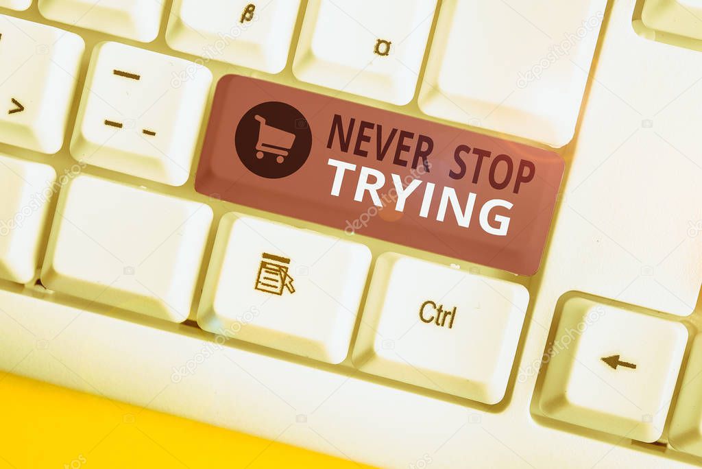 Writing note showing Never Stop Trying. Business photo showcasing Do not give up Continue to Try Again Keep on Doing White pc keyboard with note paper above the white background.