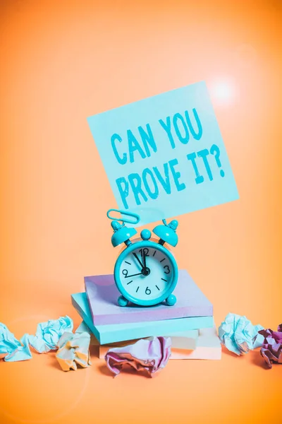 Text sign showing Can You Prove It Question. Conceptual photo Asking Someone for evidence or approval Court Alarm clock sticky note paper balls stacked notepads colored background. — Stockfoto