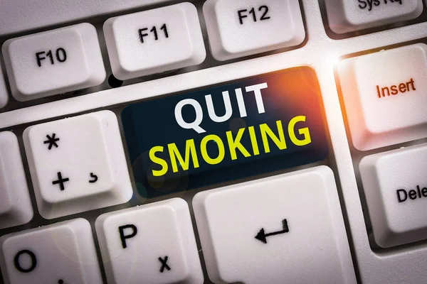 Conceptual hand writing showing Quit Smoking. Business photo text process of discontinuing tobacco smoking or cessation White pc keyboard with note paper above the white background. — Stock Photo, Image