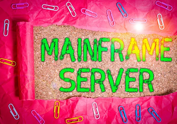 Conceptual hand writing showing Mainframe Server. Business photo showcasing designed for processing large amounts of information Paper clip and torn cardboard on wood classic table backdrop.