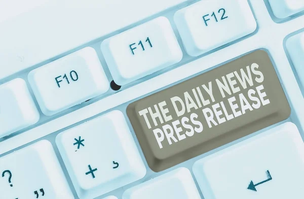 Schrijfbriefje met The Daily News Persbericht. Zakelijke foto presentatie aankondigen groot nieuws of spreken tot het tonen van witte pc toetsenbord met nota papier boven de witte achtergrond. — Stockfoto