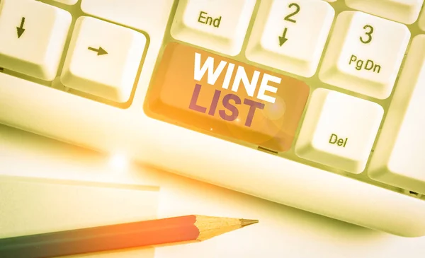 Handwriting text writing Wine List. Concept meaning menu of wine selections for purchase typically in a restaurant White pc keyboard with empty note paper above white background key copy space.