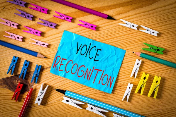 Conceptual hand writing showing Voice Recognition. Concept meaning the control of a computer system by a voice or voices Colored crumpled papers wooden floor background clothespin