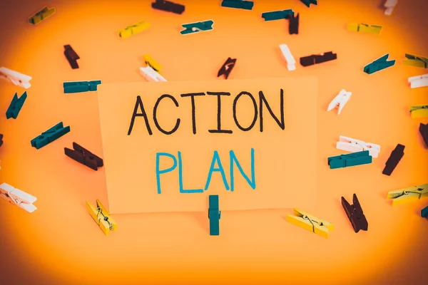 Text sign showing Action Plan. Business photo text detailed plan outlining actions needed to reach goals or vision Colored clothespin papers empty reminder yellow floor background office