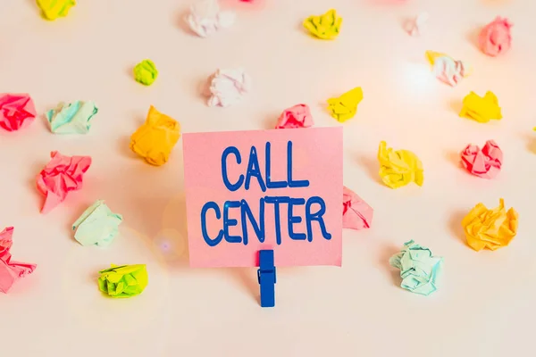 Writing note showing Call Center. Business concept for an office in which large numbers of telephone calls are handled Colored crumpled paper empty reminder white floor clothespin