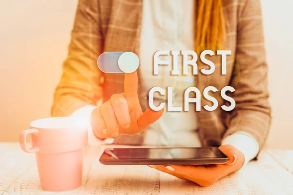 Text sign showing First Class. Business photo text the most expensive and most luxurious class of accommodation Business woman sitting with mobile phone and cup of coffee on the table