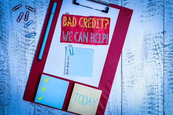 Handwriting text writing Bad Credit Question We Can Help. Conceptual photo offering help after going for loan then rejected Clipboard sheet crushed sticky note clip notepads marker wooden background